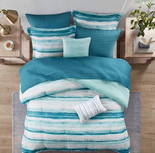 Madison Park Marina 8-piece printed seersucker comforter and coverlet set in a blue and white striped colorway king/cal king