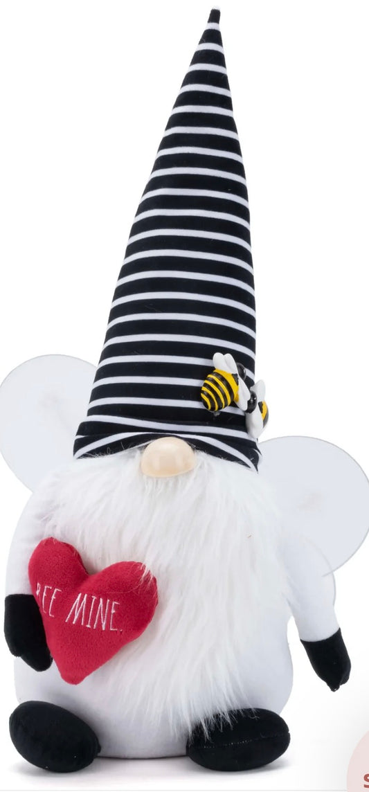 Rae Dunn Valentine's Day plush gnome featuring a black and white striped hat with bees and holding a red heart embroidered with "BEE MINE"