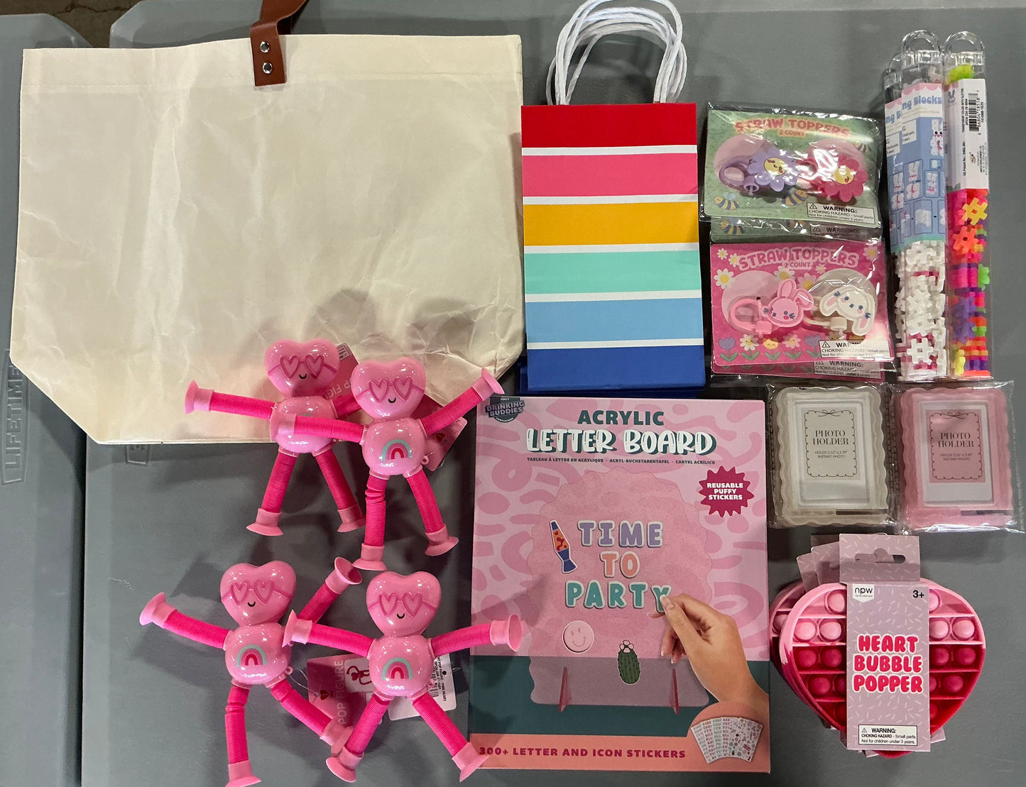 Girl’s Party Bundle (includes 1 Bulletin Board, 4 Heart Bubble Poppers, 2 Pink & 2 White Picture Frames (Holds 2.13”x3.39” instant photo), 4 Building Blocks, 4 Pink Heart Pop Figures, 2 Flower & 2 Bunny Straw Toppers, 4 Gift Bags & 1 tote