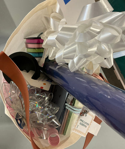 Gift Wrapping Bundle (includes 1 Tote, 1-(25sq ft)Blue Gift Wrap, 1 Clear Bow, 2 White Bows, 2 White Curling Ribbons, 2 (4 color) Curling Ribbons, 1 Curly Pink Bow, 1 (4 color) XS Gift Bags (slight damage, see picture), 1 (4 color) Small Bags)