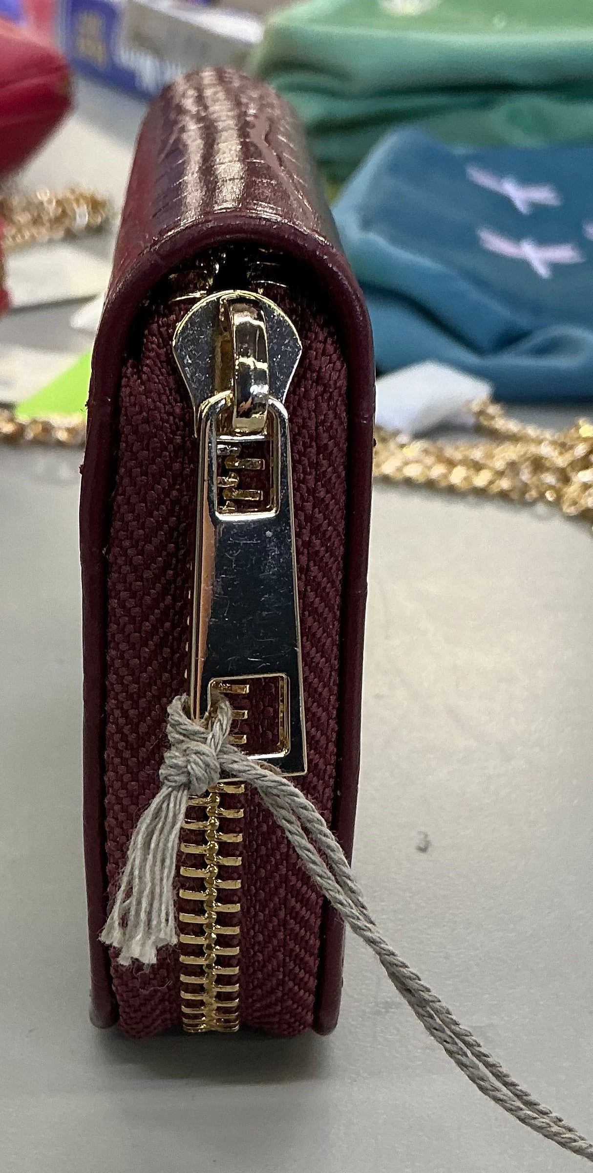 A New Day brand faux crocodile embossed wine-red zip-around wallets