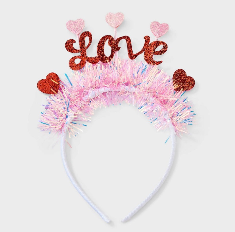 "Love" tinsel headband featuring pink and iridescent fringe with red glitter hearts