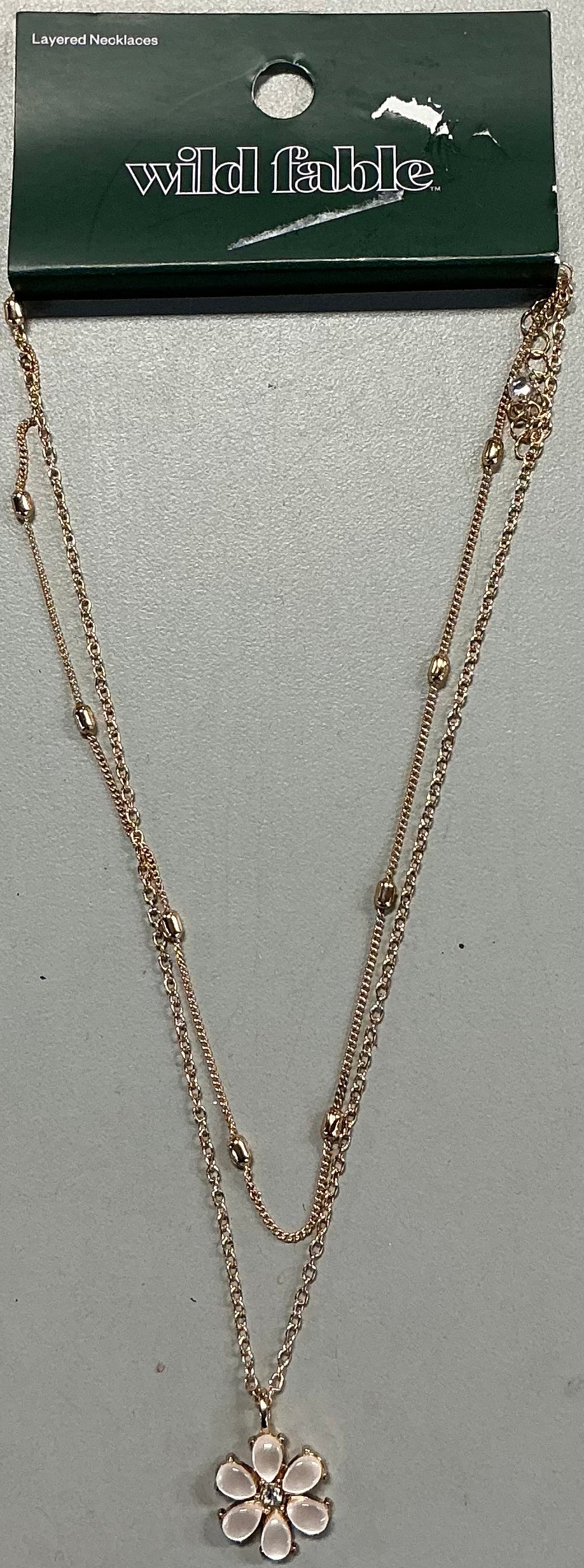 Rose gold tone Wild Fable layered necklace featuring delicate chains with small bead accents and a flower pendant