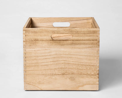 Pillowfort large wooden storage bin featuring a natural wood grain finish and cutout handles 14” L X 13” W X 11” H
