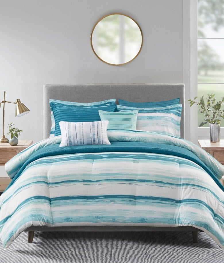 Madison Park Marina 8-piece printed seersucker comforter and coverlet set in a blue and white striped colorway king/cal king