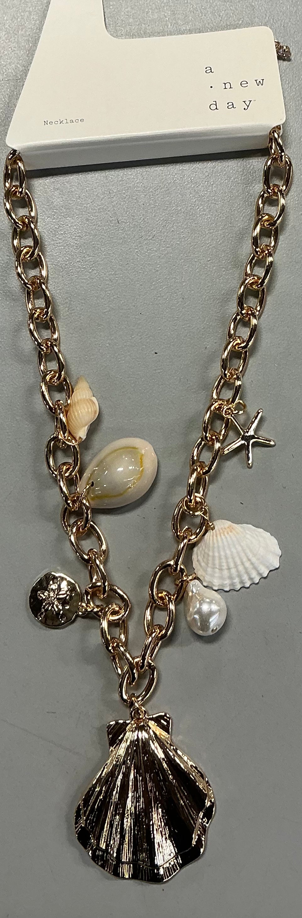 Gold-colored charm necklace featuring various seashell and starfish charms