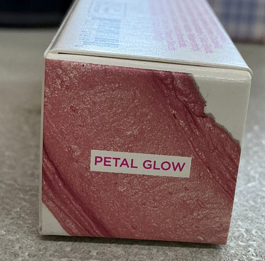 Petite 'n Pretty The Glow Up All Over Stick in a shimmering formula suitable for eyes, lips, and cheeks