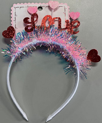 "Love" tinsel headband featuring pink and iridescent fringe with red glitter hearts