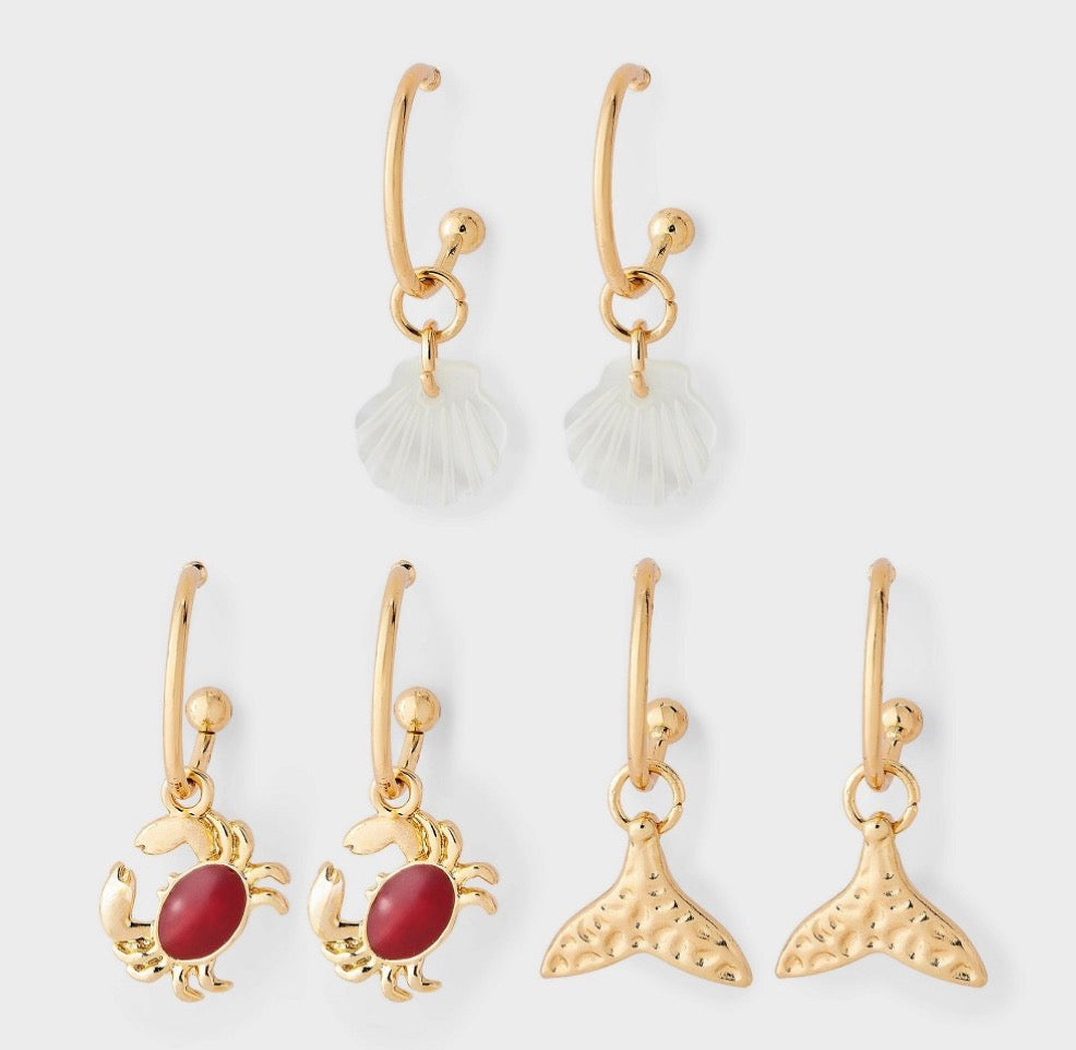 Gold-tone hoop earrings featuring assorted ocean-themed charms