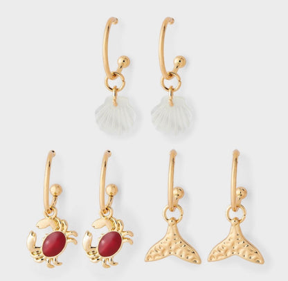 Gold-tone hoop earrings featuring assorted ocean-themed charms