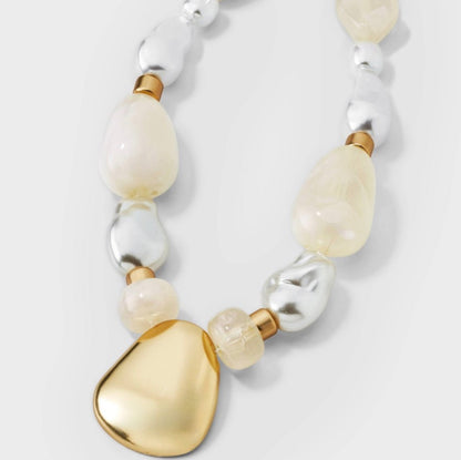 Beaded pendant necklace featuring white faux pearls and a matte gold-tone pendant-As Is