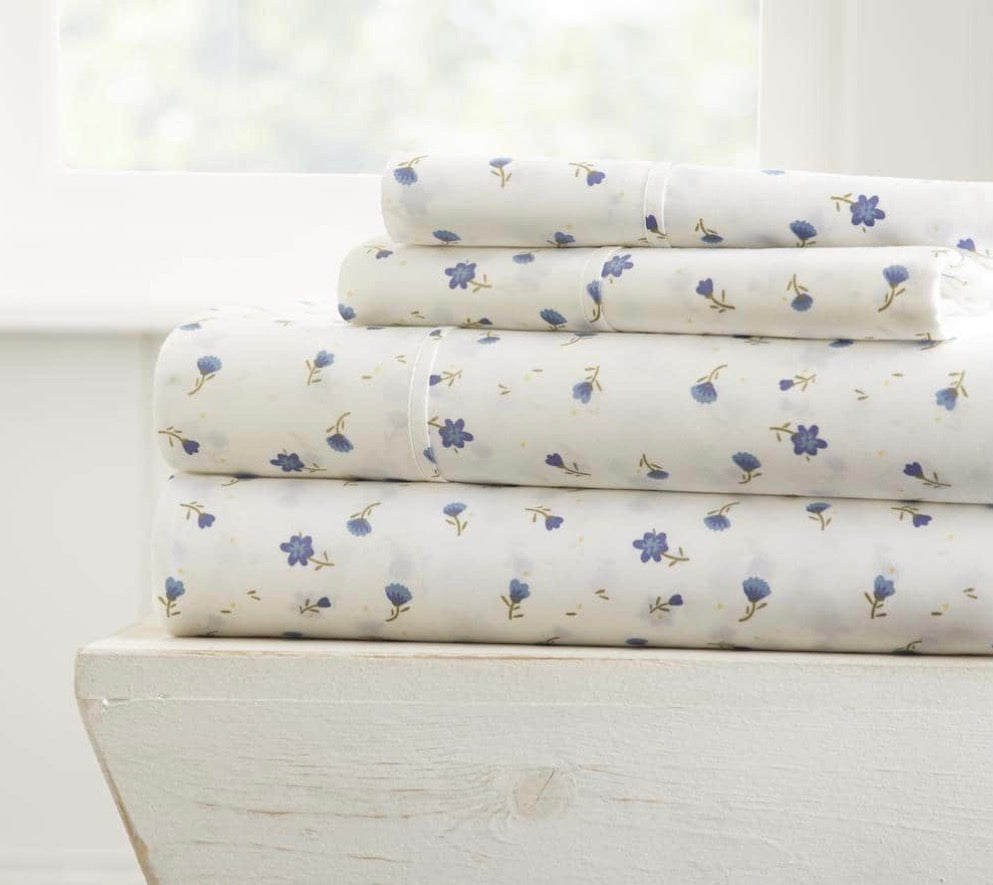 4-Piece King Floral Patterned Sheet Set featuring a light blue floral design on a white background