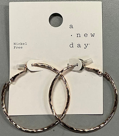 Rose gold plated hoop earrings featuring a textured design
