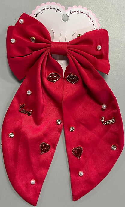 Red satin bow hair barrette adorned with pearl beads, rhinestone crystals, lips, and "love" charms