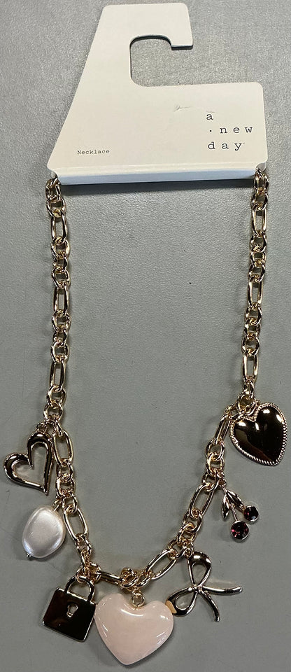Gold-tone necklace featuring heart, pearl, and cherry charms