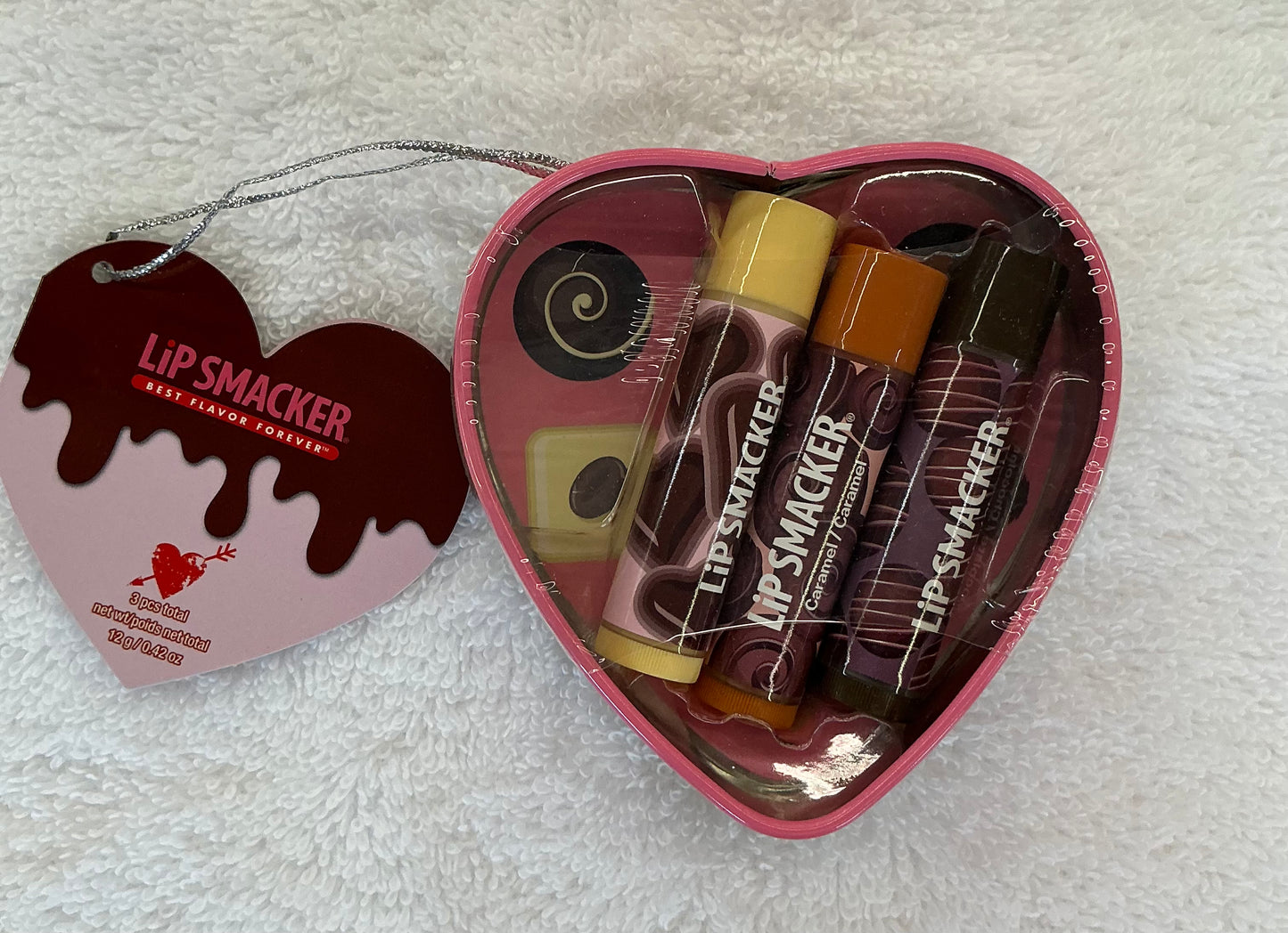 Lip Smacker Chocolate Deluxe Heart Tin Lip Balm Trio featuring coconut, chocolate, and caramel flavors in a pink heart-shaped