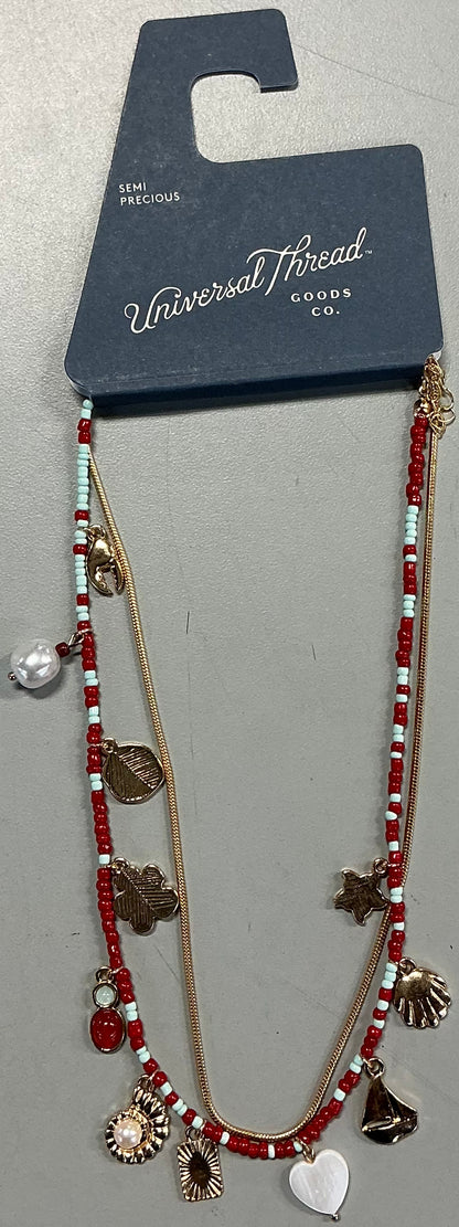 2-piece necklace set featuring a red beaded strand with various charms and a gold-tone snake chain