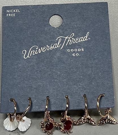 Gold-tone hoop earrings featuring assorted ocean-themed charms