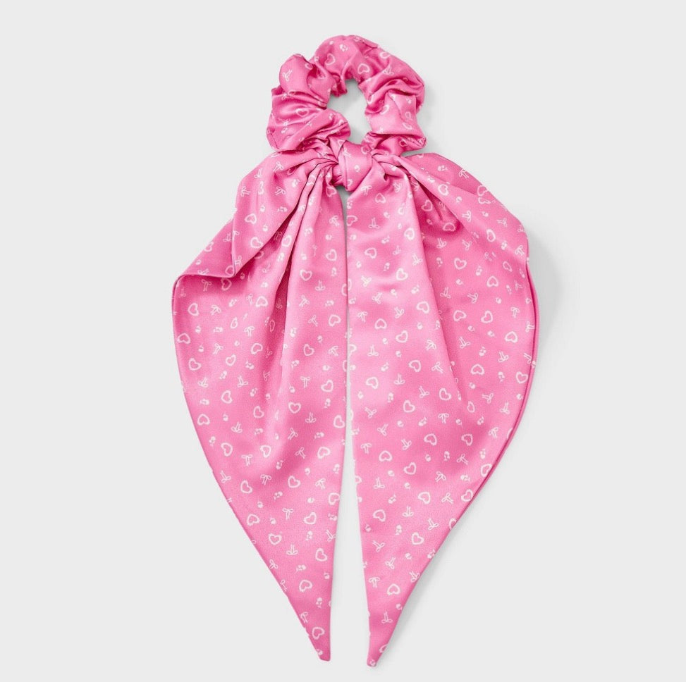 Pink satin hair twister featuring a white heart and bow print with long tails
