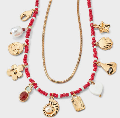 2-piece necklace set featuring a red beaded strand with various charms and a gold-tone snake chain